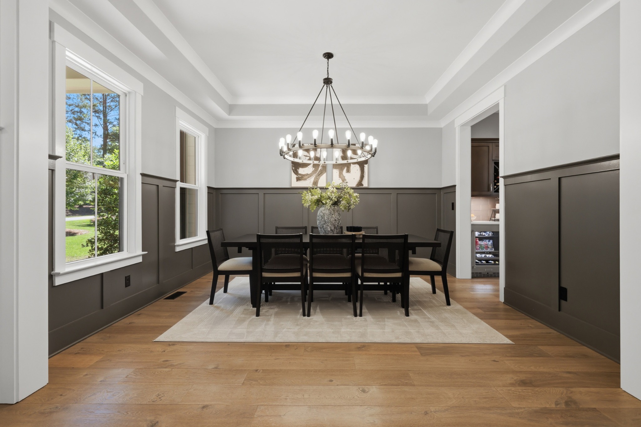 Silver Falls dining room with warm wood table and black chandelier