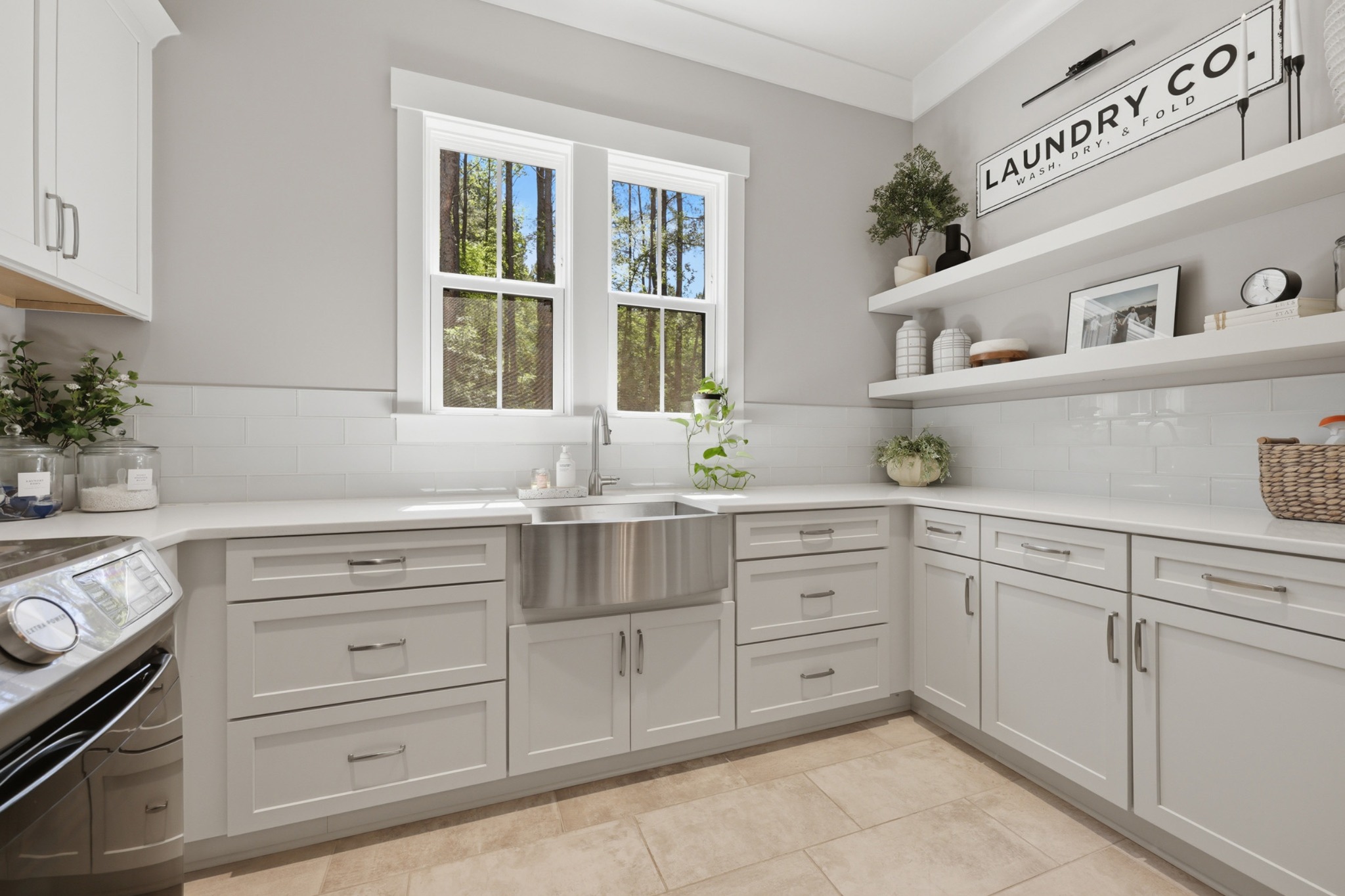 Silver Falls laundry room with white cabinetry and open shelving