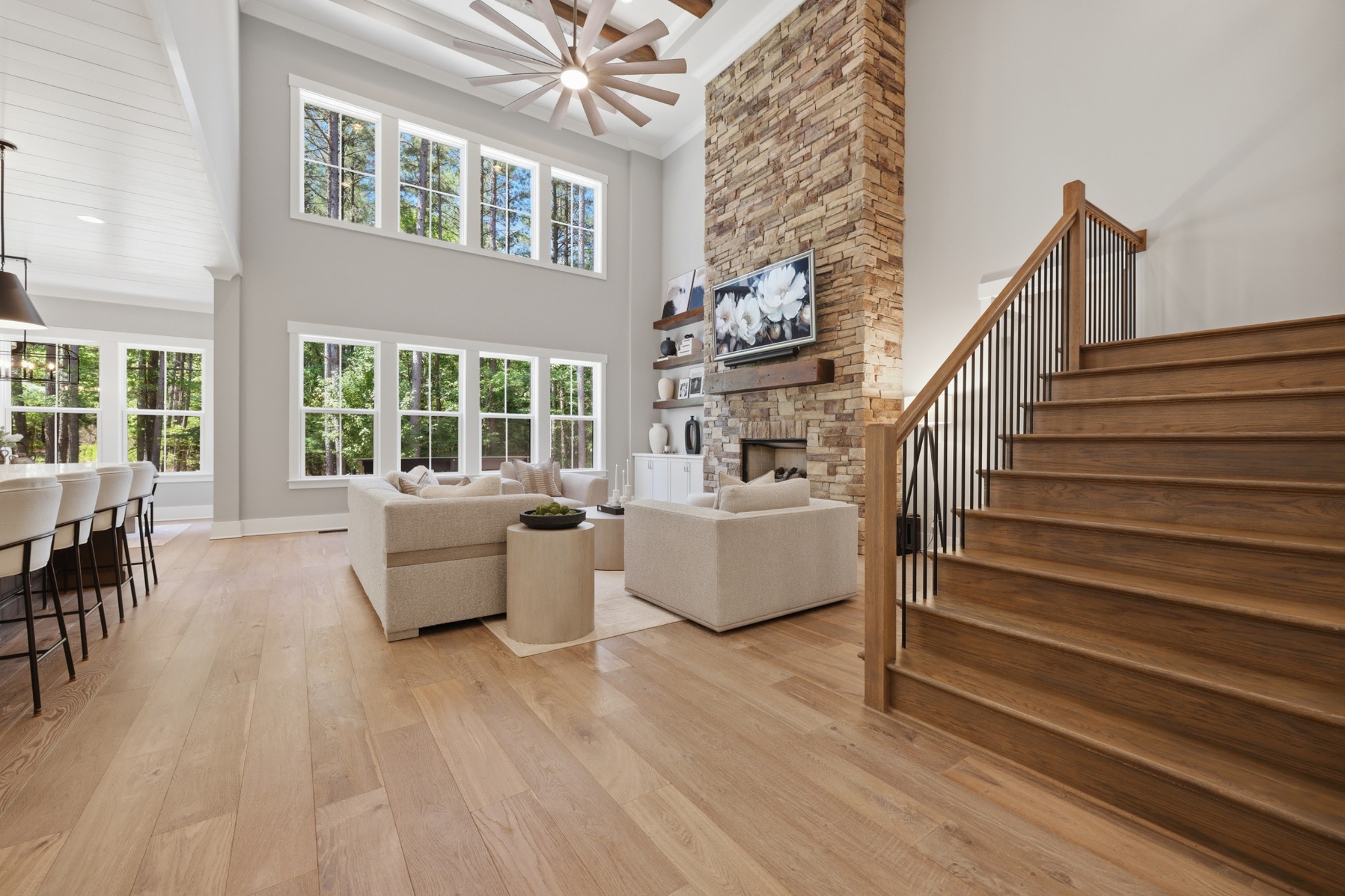 Silver Falls living room with stone fireplace and open staircase